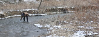 Sample Collection A Red Flag volunteer collects a sample from a frigid stream.
